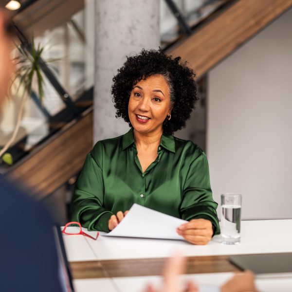 Women sat at an office table discussing CY Insolvency & Restructuring solutions