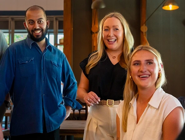 Three colleagues smiling together, part of a professional insolvency practitioner team.